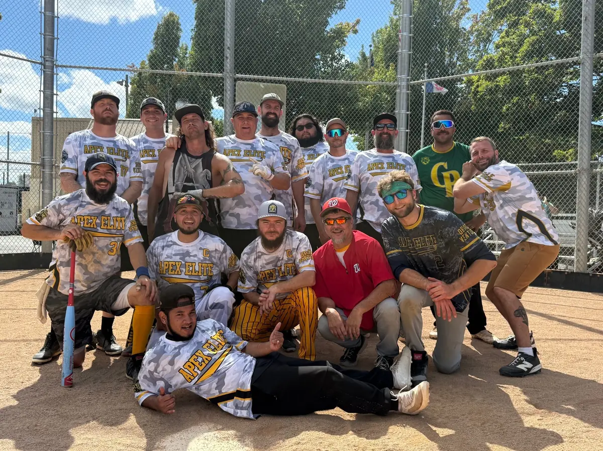The Apex Elite team posing on the infield after a game